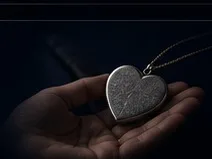 A heart-shaped keepsake held in a hand